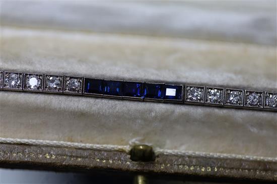 A 1920s 18ct white gold, sapphire and diamond set line bracelet, in original fitted Charles Packer & Co Ltd box.